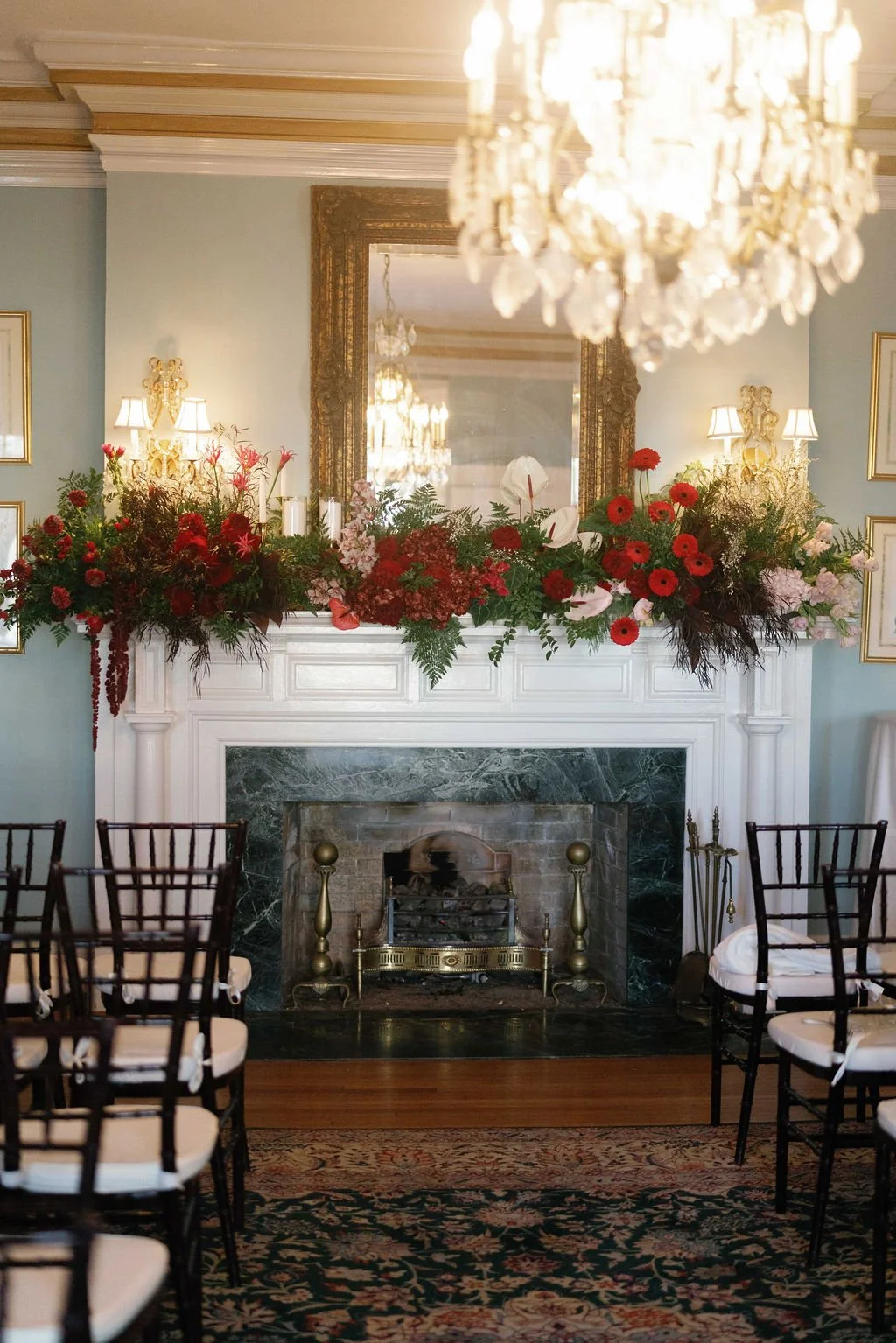 Ceremony mantel draped in red garden roses and greenery