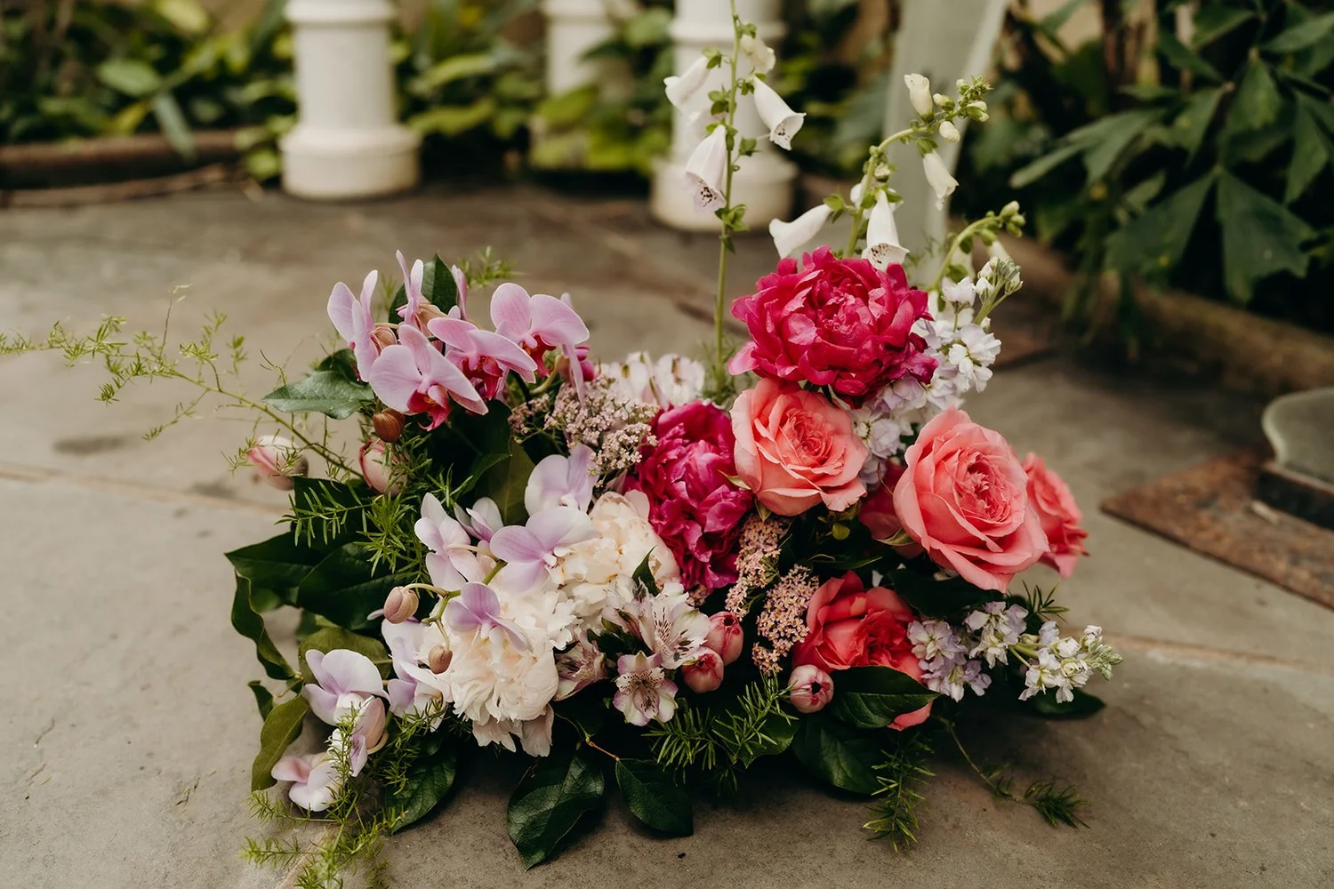 Garden-inspired ground arrangement of peonies, roses and foxglove